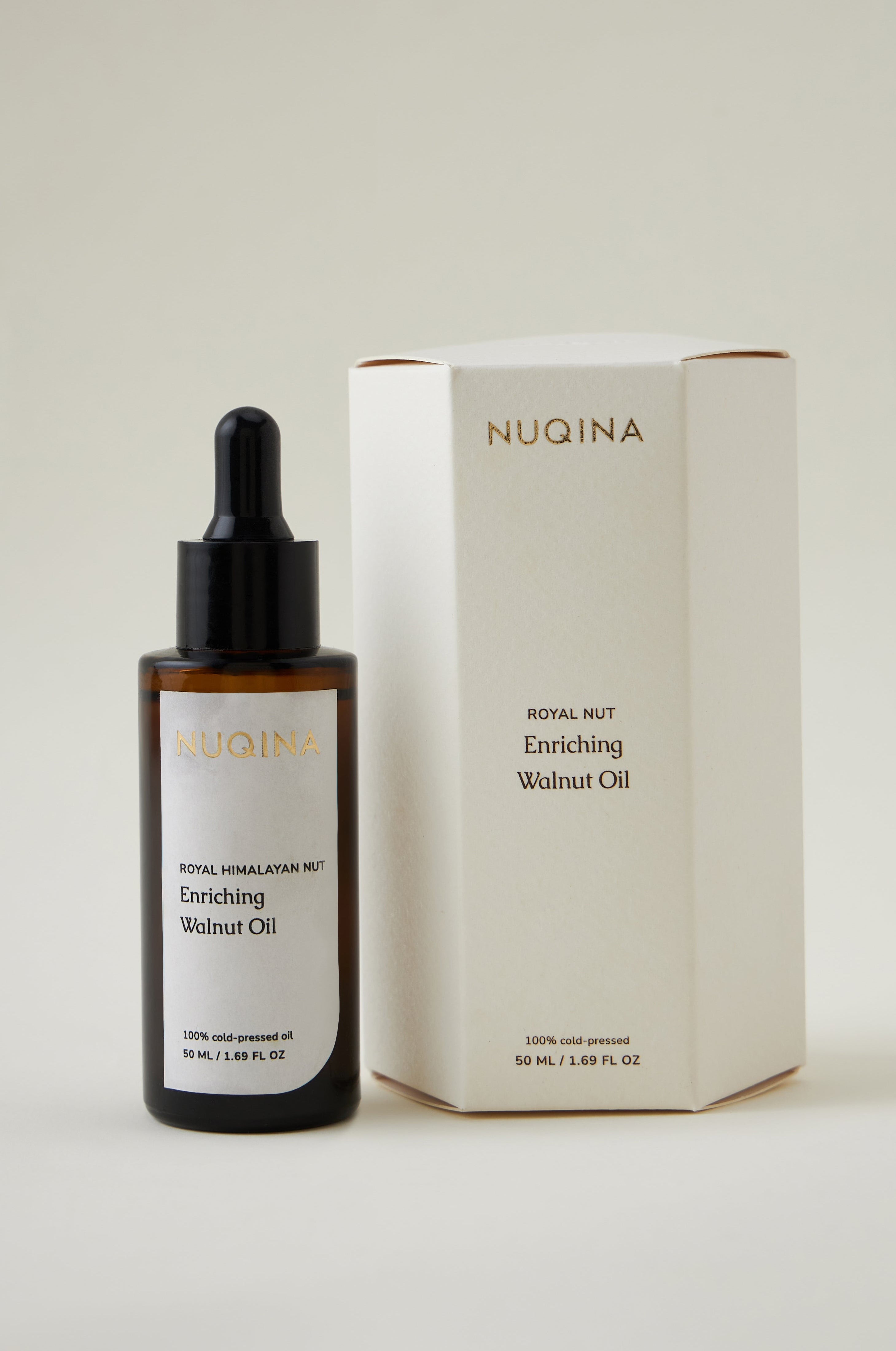 NUQINA enriching walnut oil bottle and packaging on a light background